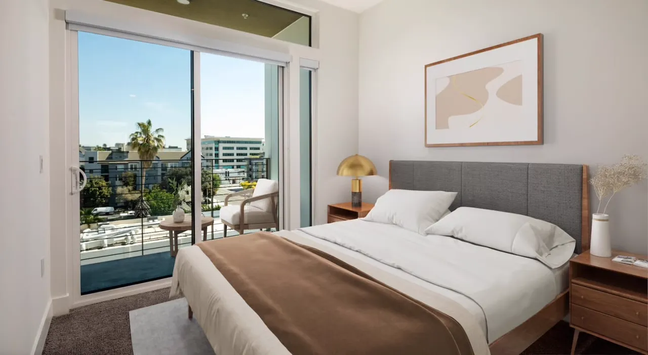 Spacious bedroom with private balcony and city views